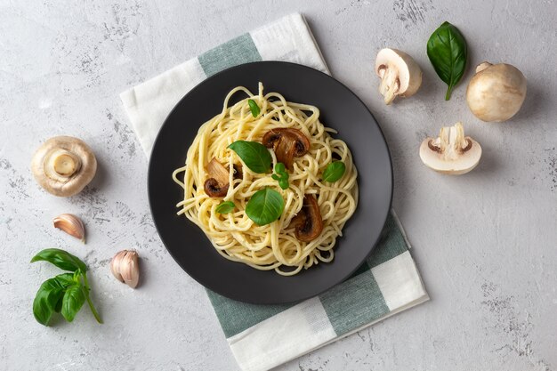 spaghetti-with-mushrooms-cream-sauce-light-space_147689-349